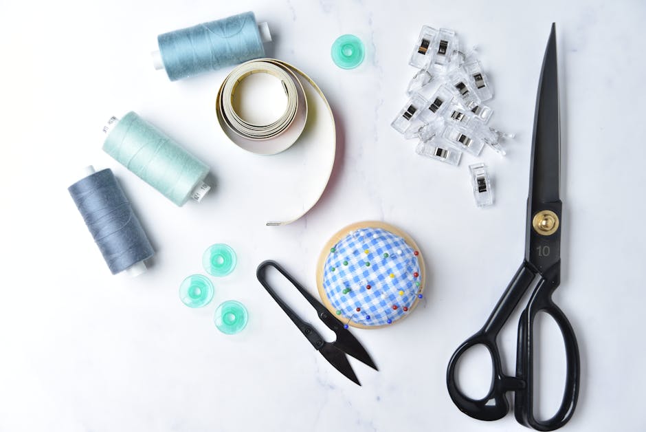 A collection of sewing essentials arranged on a white surface for craft enthusiasts.